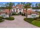 Stunning exterior featuring a tile roof, arched entry, and manicured landscaping at 17124 Crawley Rd, Odessa, FL 33556