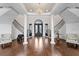 Grand foyer with sweeping staircases, soaring ceilings, and elegant chandelier at 17124 Crawley Rd, Odessa, FL 33556