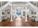Elegant foyer with grand staircase, gleaming hardwood floors, and breathtaking lake views beyond at 17124 Crawley Rd, Odessa, FL 33556