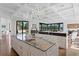 Gourmet kitchen features a spacious island, custom cabinetry, stainless steel appliances, and an open layout at 17124 Crawley Rd, Odessa, FL 33556