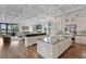 Open-concept kitchen with large island, granite countertops, custom cabinets, and seamless flow to living area at 17124 Crawley Rd, Odessa, FL 33556