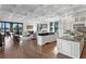 Open-concept kitchen with a large island, granite countertops, stainless steel appliances, and lake views at 17124 Crawley Rd, Odessa, FL 33556