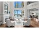 Bright living room with fireplace and views of the pool and lake at 17124 Crawley Rd, Odessa, FL 33556