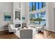 Bright living room features a fireplace, high ceilings and a wall of windows with pool and lake views at 17124 Crawley Rd, Odessa, FL 33556