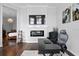 Beautiful living room area featuring hardwood floors, a fireplace, and a comfortable seating area at 17124 Crawley Rd, Odessa, FL 33556