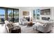 Cozy living room with large windows, comfortable seating, and a view of the lake at 17124 Crawley Rd, Odessa, FL 33556