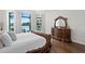 Serene main bedroom with wood floors, a chandelier, and views of the lake at 17124 Crawley Rd, Odessa, FL 33556