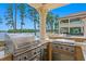 Outdoor kitchen with stainless steel grill offering beautiful views of the lake and backyard patio at 17124 Crawley Rd, Odessa, FL 33556