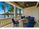 Inviting covered patio with comfortable seating offers scenic lake views for relaxing or entertaining at 17124 Crawley Rd, Odessa, FL 33556