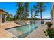 Stunning infinity pool and spa overlooking serene lake views with manicured landscaping and tiled accents at 17124 Crawley Rd, Odessa, FL 33556