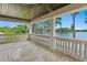 Spacious porch with stone flooring and views of a lake with trees at 17124 Crawley Rd, Odessa, FL 33556