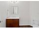 Powder room with modern vanity, featuring wood cabinet and updated fixtures for guests at 17124 Crawley Rd, Odessa, FL 33556