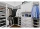 Spacious walk-in closet with custom shelving and storage for shoes, clothing, and accessories at 17124 Crawley Rd, Odessa, FL 33556