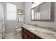 Granite countertop vanity, large mirror, with shower and toilet in this light and airy bathroom at 17318 Emerald Chase Dr, Tampa, FL 33647