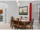 Dining room area featuring neutral decor, tile flooring, and a painting of a ship at 17318 Emerald Chase Dr, Tampa, FL 33647