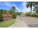 Club Tampa Palms entrance features a brick sign, lush landscaping, and access to a brick-paved drive at 17318 Emerald Chase Dr, Tampa, FL 33647
