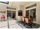 Bright lanai with large sliding glass doors and outdoor dining table set on a patterned rug at 17318 Emerald Chase Dr, Tampa, FL 33647