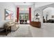 Bright living area featuring neutral decor, tile flooring, access to a pool area and seamless flow to other rooms at 17318 Emerald Chase Dr, Tampa, FL 33647
