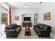 Bright living room with black leather couches, media center and view of the pool area at 17318 Emerald Chase Dr, Tampa, FL 33647