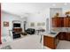 Open-concept living room featuring leather sofas, tile flooring, and a partial view of the kitchen at 17318 Emerald Chase Dr, Tampa, FL 33647