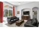 Sunlit living room with comfortable seating, entertainment center, and a glimpse of the outdoor pool at 17318 Emerald Chase Dr, Tampa, FL 33647