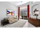 Bright living room featuring neutral furniture, red curtains, and sliding glass doors to the pool area at 17318 Emerald Chase Dr, Tampa, FL 33647