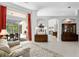 Bright living area featuring neutral decor, tile flooring, access to a lanai and seamless flow to other rooms at 17318 Emerald Chase Dr, Tampa, FL 33647