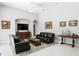 Spacious living room with two sofas, tile flooring, and arched doorways, perfect for entertaining guests at 17318 Emerald Chase Dr, Tampa, FL 33647