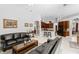 Open living area showcasing modern furnishings, tile flooring, and partial views of the kitchen and dining space at 17318 Emerald Chase Dr, Tampa, FL 33647
