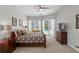 Bright main bedroom with a ceiling fan, large window, and glass door to the outdoor pool at 17318 Emerald Chase Dr, Tampa, FL 33647