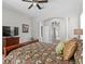 Bright main bedroom with a ceiling fan, large window, and glass door to the outdoor pool at 17318 Emerald Chase Dr, Tampa, FL 33647