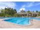 Resort style community pool with plenty of tables, chairs, and umbrellas for residents to enjoy at 17318 Emerald Chase Dr, Tampa, FL 33647