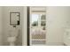 Clean bathroom showcases a toilet, vanity with a view into the bedroom, offering a glimpse of comfort at 18461 Serene Lake Loop, Lutz, FL 33548