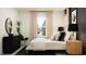 Well-decorated bedroom with large window for natural light, modern furniture, and chic decor at 18461 Serene Lake Loop, Lutz, FL 33548