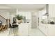 Bright kitchen with white cabinets, stainless steel appliances, and a center island with barstool seating at 18461 Serene Lake Loop, Lutz, FL 33548
