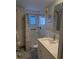 Well-lit bathroom features a new vanity and shower with stylish fixtures at 1898 Shore S Dr # 311, South Pasadena, FL 33707