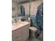 Cozy bathroom with a white vanity, mirror, and toilet with a decorative shower curtain at 1898 Shore S Dr # 311, South Pasadena, FL 33707