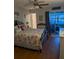 Comfortable bedroom with a decorative iron bed frame, tropical-themed linens, and sliding glass doors at 1898 Shore S Dr # 311, South Pasadena, FL 33707