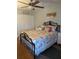 Charming bedroom with a decorative iron bed frame, tropical-themed linens, and white closet doors at 1898 Shore S Dr # 311, South Pasadena, FL 33707
