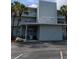 Exterior view of Shore Manor featuring palm trees and an awning over the entrance at 1898 Shore S Dr # 311, South Pasadena, FL 33707