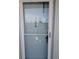 Close-up of the unit's front door, with welcome decor, and peephole at 1898 Shore S Dr # 311, South Pasadena, FL 33707