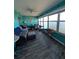 Enclosed sunroom with water views, comfortable seating, and durable wood laminate flooring at 1898 Shore S Dr # 311, South Pasadena, FL 33707