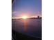 Scenic water view showcasing a radiant sunset over a body of water and silhouetted buildings at 1898 Shore S Dr # 311, South Pasadena, FL 33707