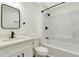 Updated bathroom features modern vanity, framed mirror, and shower over tub at 1914 E Emma St, Tampa, FL 33610