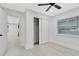 Clean bedroom featuring a ceiling fan and large closet with double sliding doors at 1914 E Emma St, Tampa, FL 33610