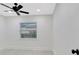 Bright bedroom with ceiling fan and window bringing in natural light at 1914 E Emma St, Tampa, FL 33610