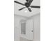 Light filled bedroom showing a ceiling fan, and an opened door showing access to another room at 1914 E Emma St, Tampa, FL 33610