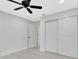 This is a bedroom featuring modern ceiling fan, and a closet with double doors at 1914 E Emma St, Tampa, FL 33610