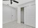 This bedroom includes a closet with double doors and view into the laundry room at 1914 E Emma St, Tampa, FL 33610