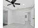 Bright bedroom features a ceiling fan, white walls, and an ensuite bathroom with a glass-enclosed shower at 1914 E Emma St, Tampa, FL 33610